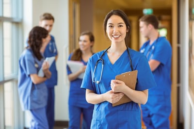 Sonography school student smiling at the camera in the halls