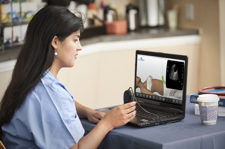 Woman scanning in the SonoSimulator as part of her ultrasound training for physicians